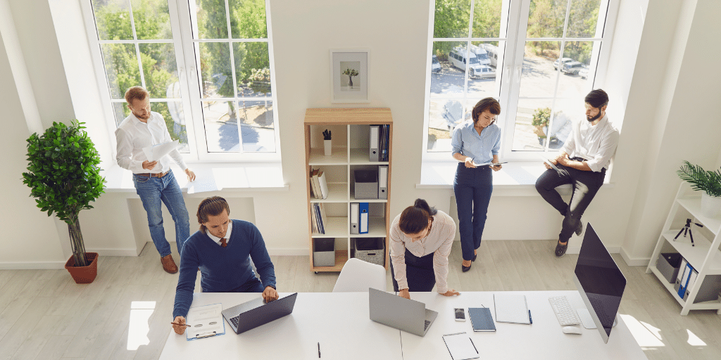 group of employees working in a bright room