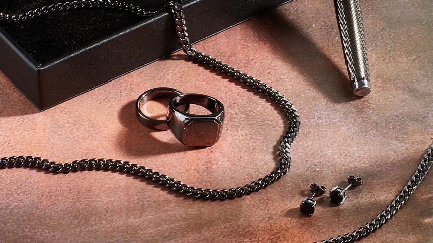 black necklace and two black rings